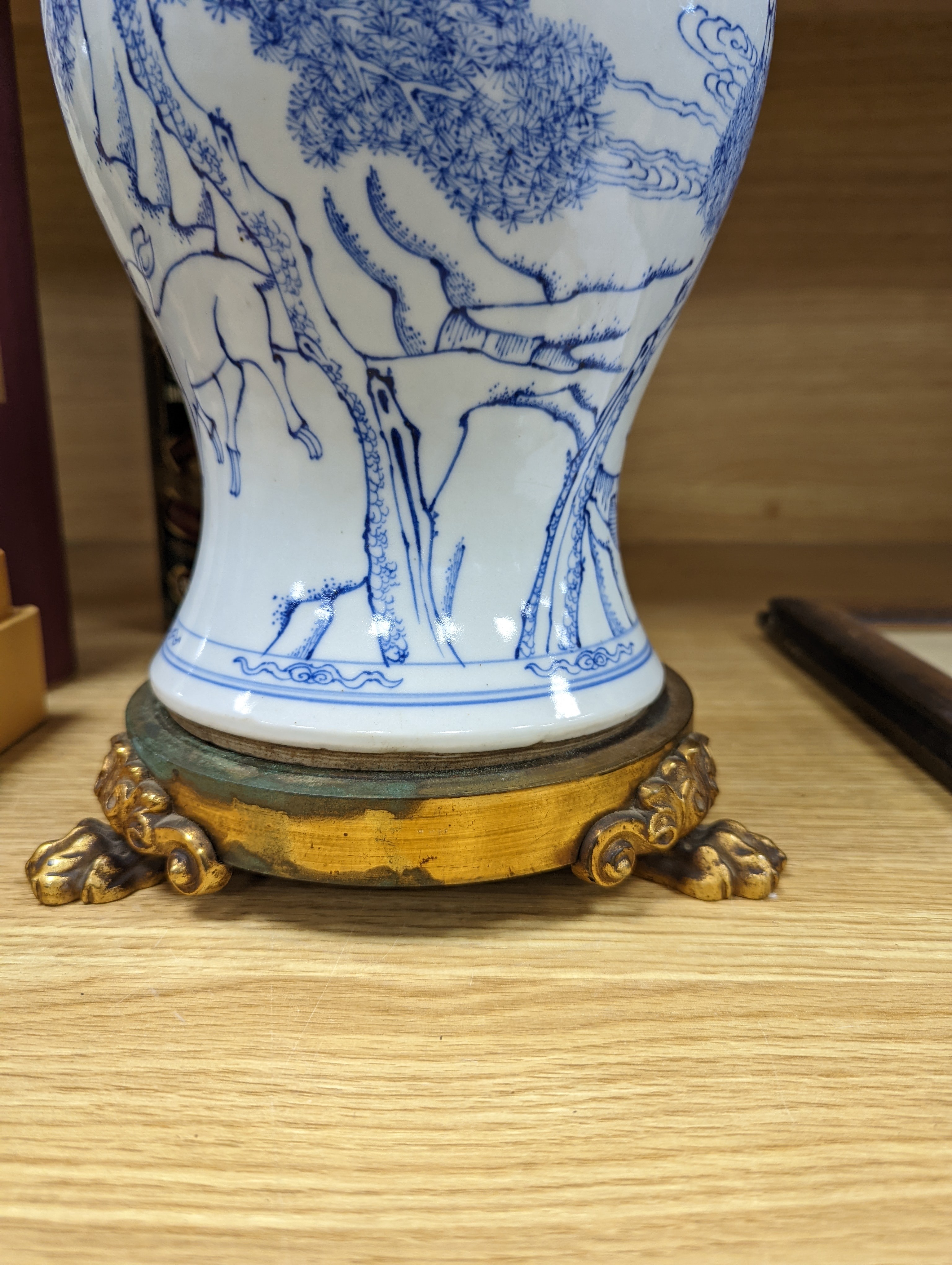 A Chinese blue and white baluster vase, brass mounted 29cm